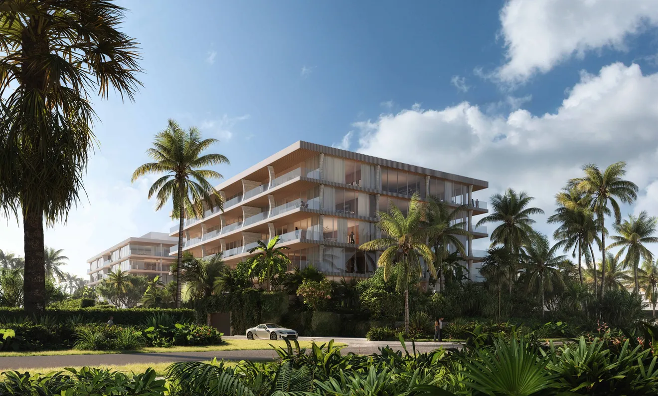 Two buildings through tropical landscape